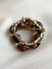Ronde broche met bruine kralen