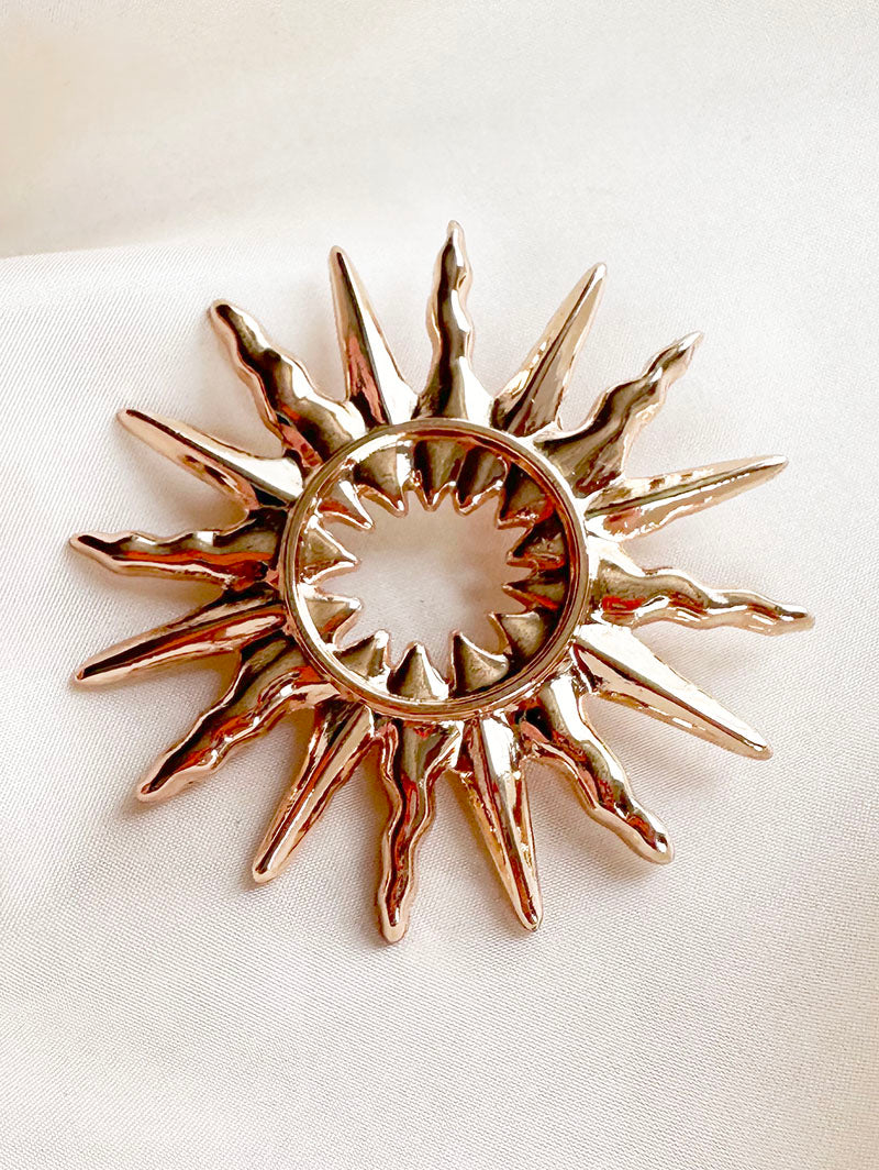 Gouden sunburst broche