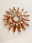 Gouden sunburst broche