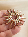 Gouden sunburst broche