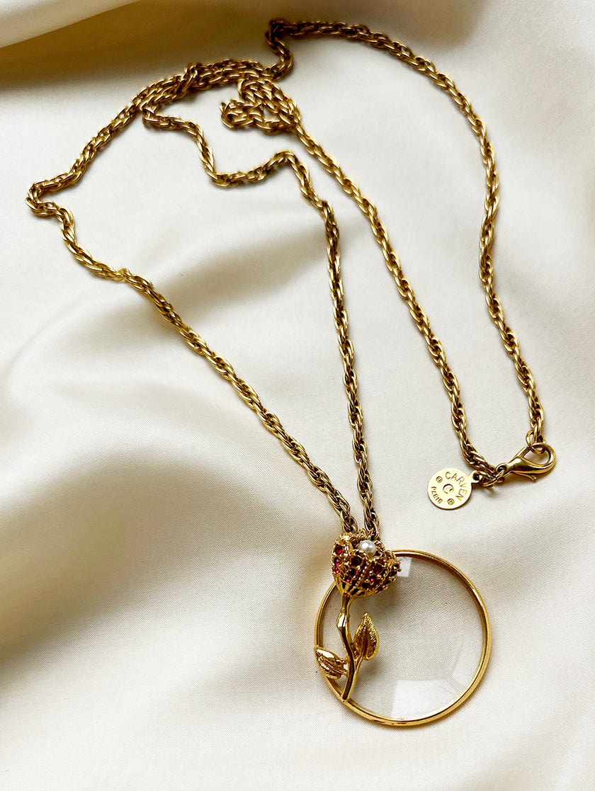 Vergulde designerketting met vergrootglas