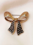 Goud/zilveren strik broche