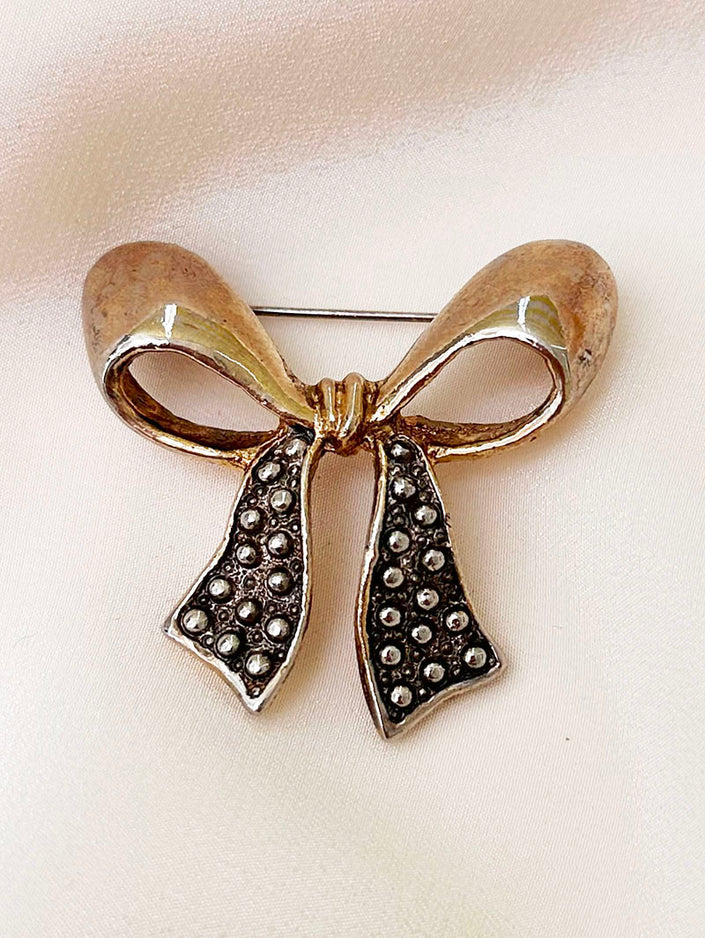 Goud/zilveren strik broche