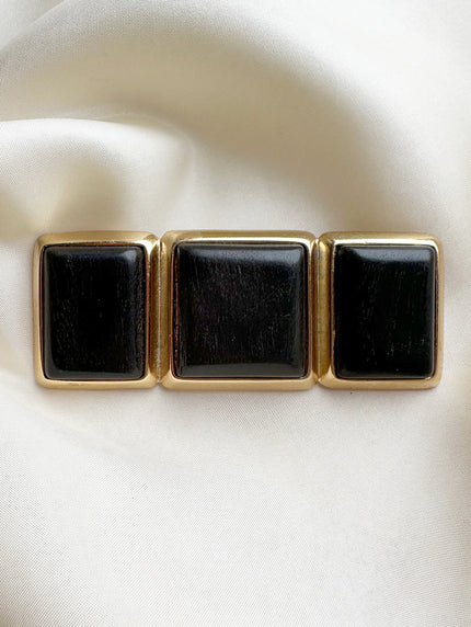 Vergulde designerbroche met ebbenhout