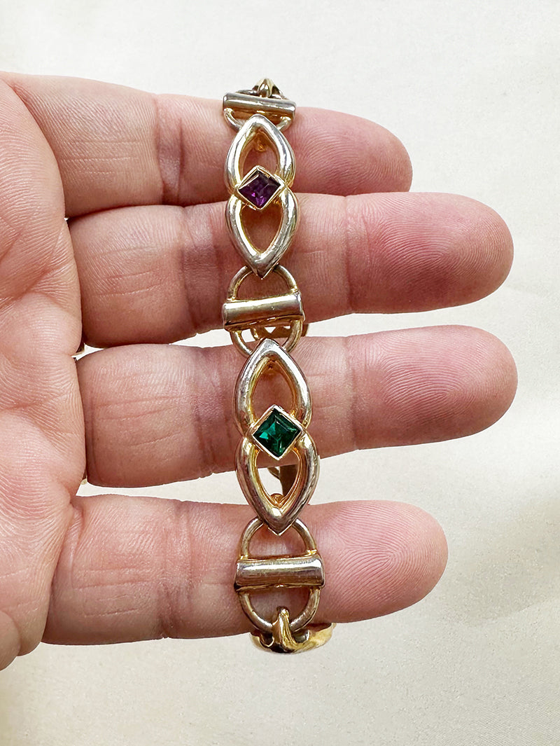 Gouden schakelarmbandje met gekleurde steentjes