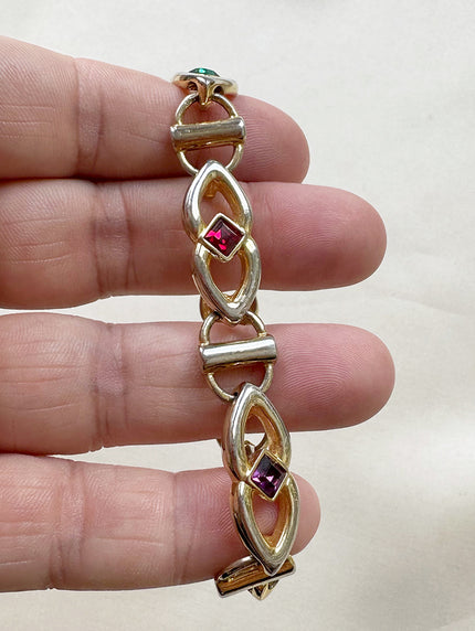 Gouden schakelarmbandje met gekleurde steentjes