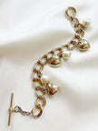 Gouden bedelarmband met hartjes en parels